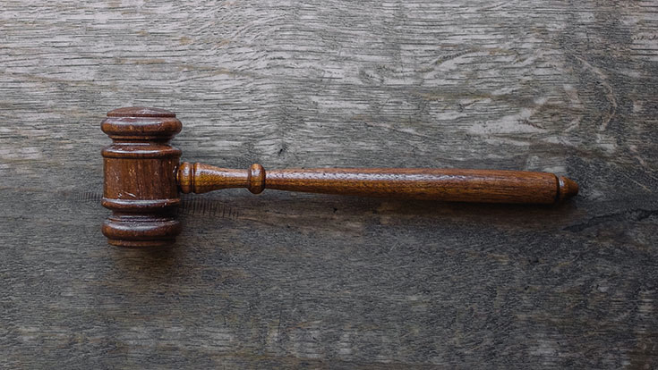 A judge's gavel lying on a table